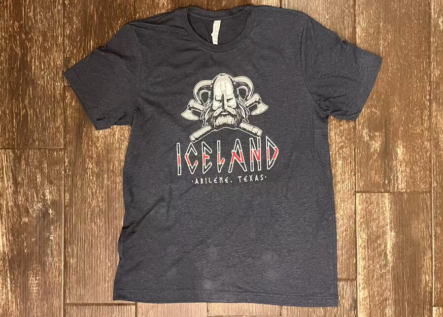 Dark gray Iceland Coolers T-shirt featuring Viking skull and crossed axe design with “Abilene, Texas” text on front.