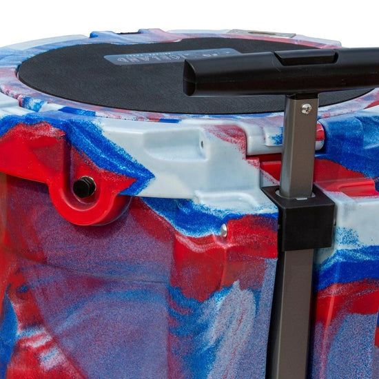Close-up of Iceland Coolers 7.5-gal red, white & blue cooler showing textured lid and telescoping handle for easy rolling transport.