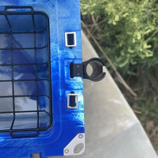 Close-up of blue Iceland Cooler with mounted rod holder and interior wire basket, ideal for hands-free fishing and outdoor storage.