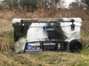 Iceland Coolers Longship Series 110-quart roto-molded wheeled cooler in camo design, shown outdoors in a grassy field.