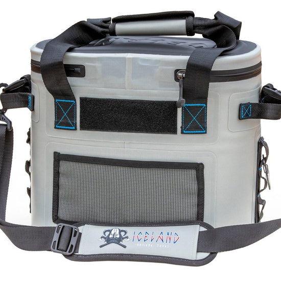 Rear view of gray Iceland Coolers Saga Series 12-can soft cooler with mesh pocket, padded strap, and black-blue stitching.